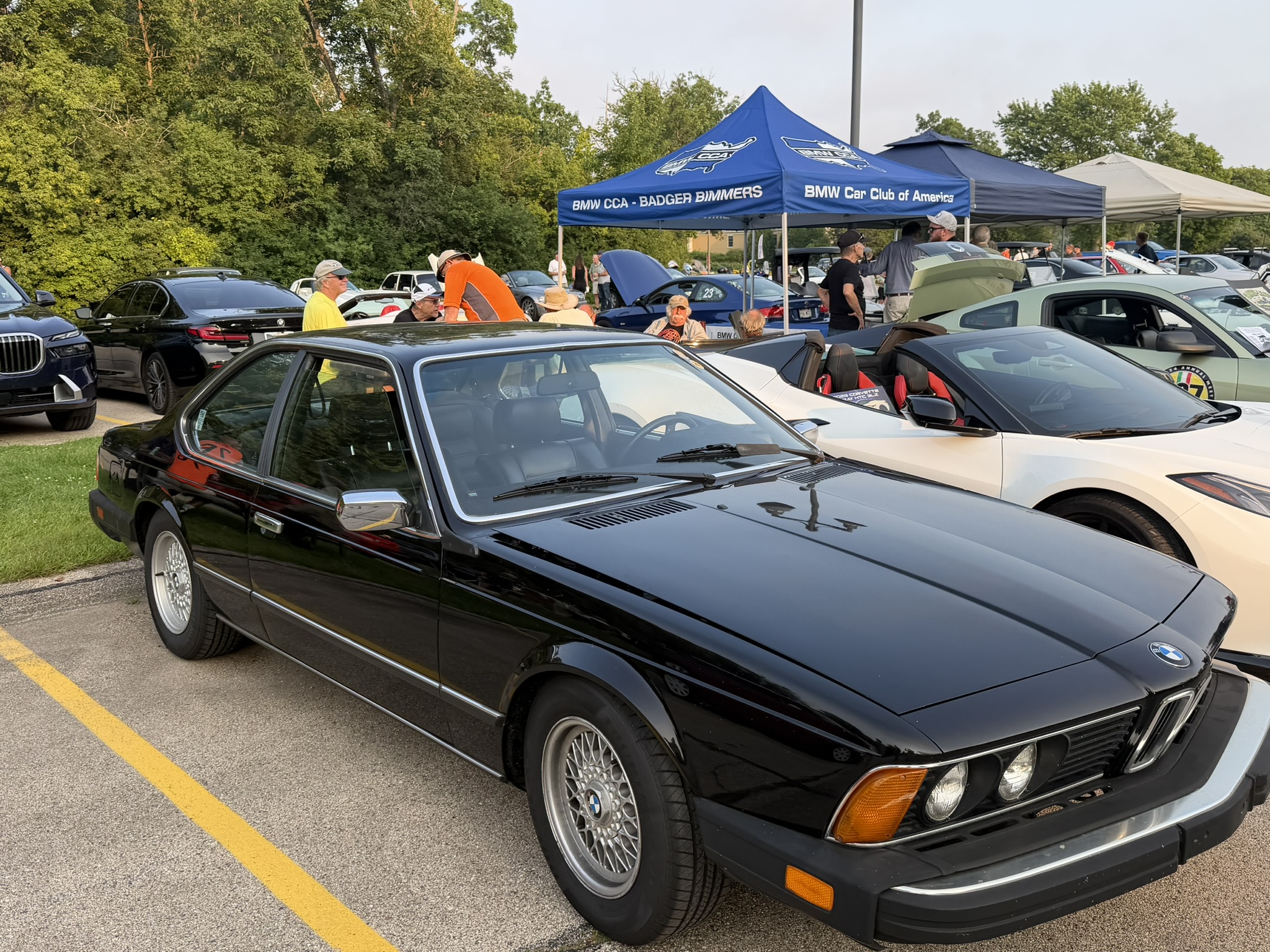 Black BMW E24 parked by the BMW CCA Badger Bimmers tent at Brew City Cruise Night
