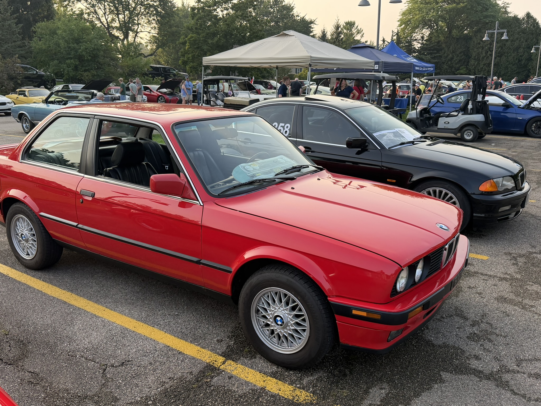 Red classic BMW E30 displayed at BMW and MINI Night in Mequon