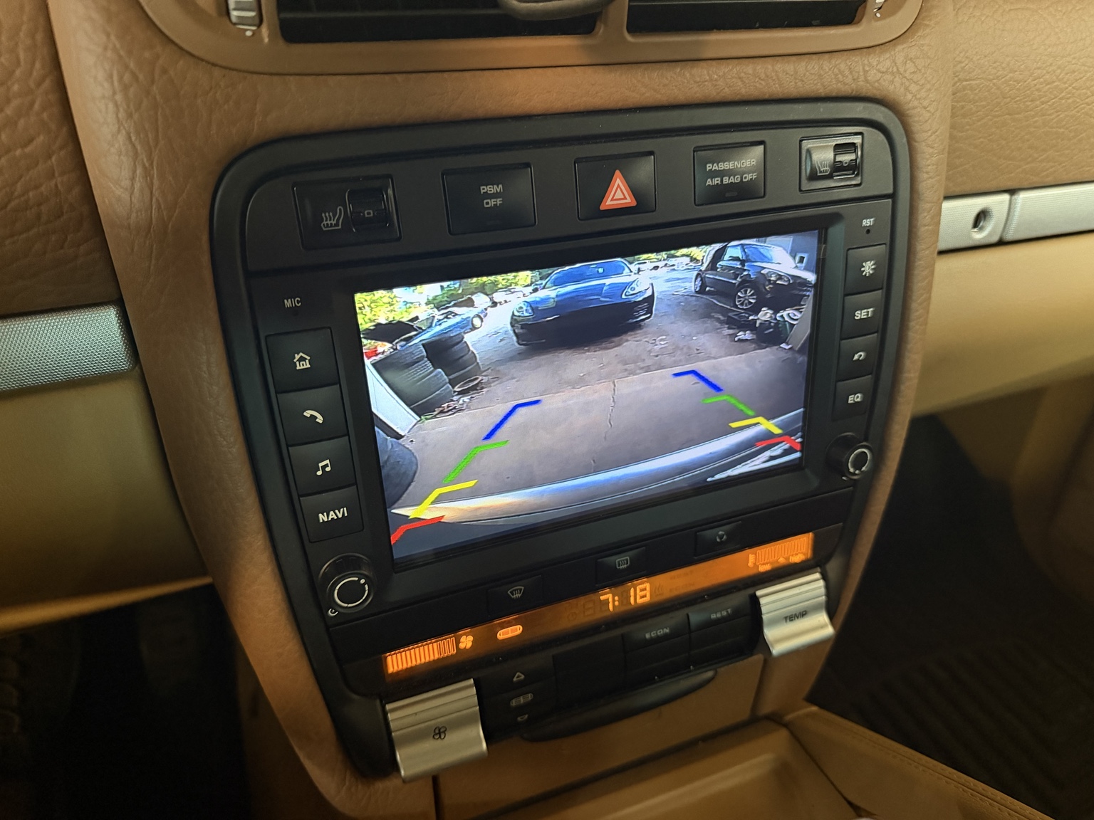 OEM style backup camera installation displayed in a Porsche Cayenne