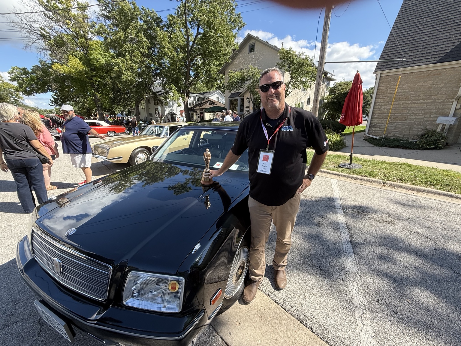 Ryan beside a collector car at a Wisconsin automotive event